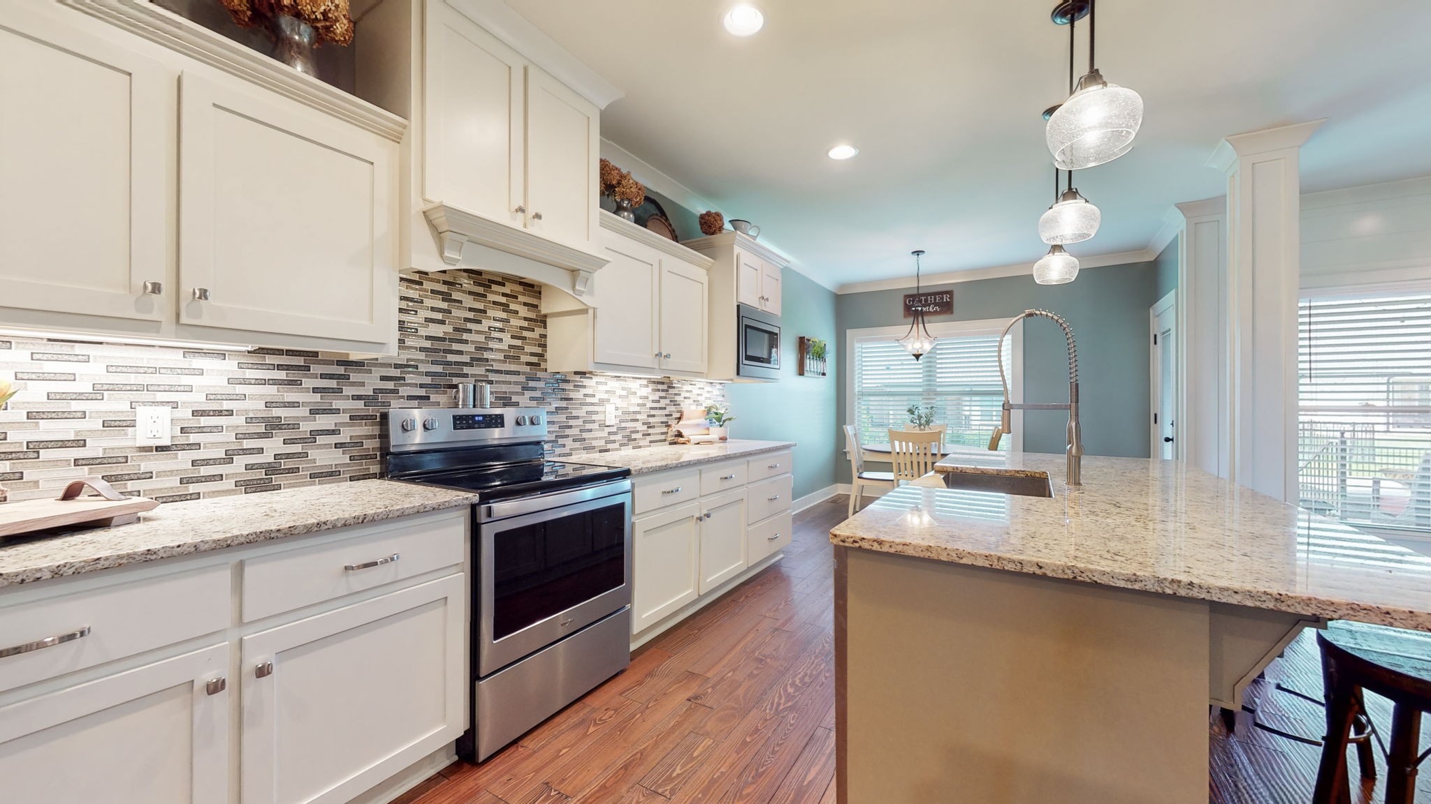 4017 Merryman Lane Murfreesboro, TN 37127 - Photo 18 of 62 a kitchen with stainless steel appliances granite countertop a sink dishwasher a stove and white cabinets with wooden floor