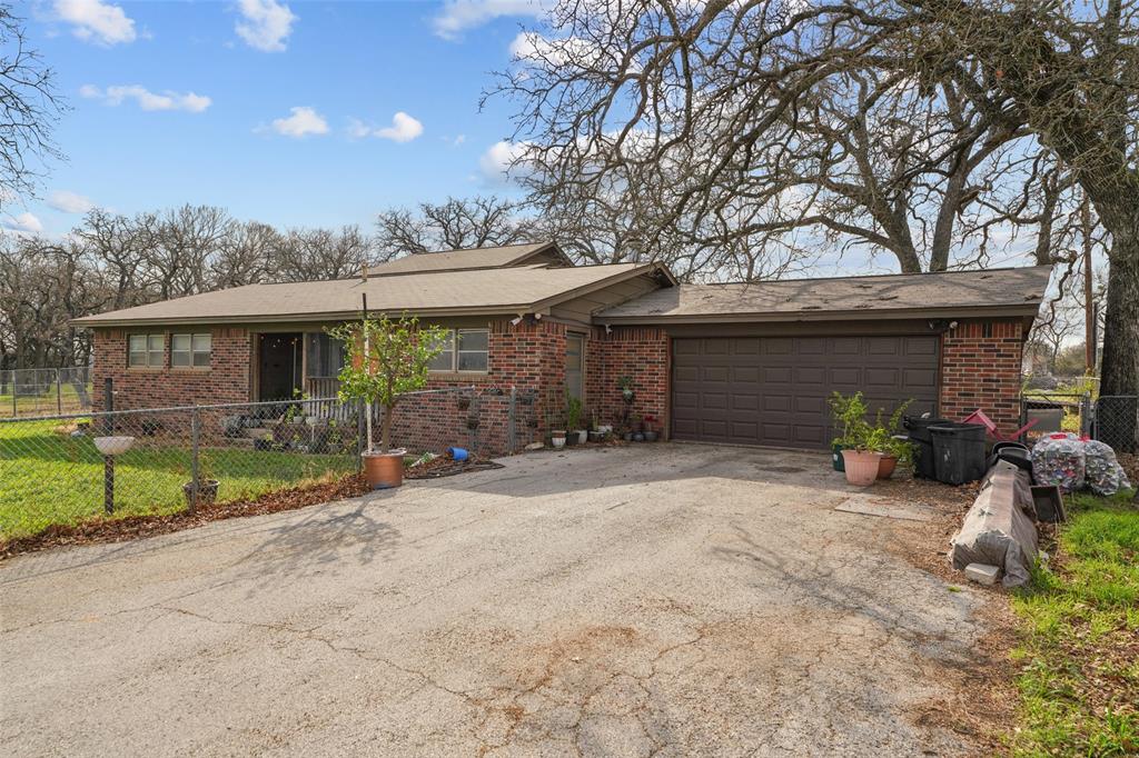 1051 Lynch Bend Road Springtown, TX 76082 - Photo 32 of 39 a view of a house with backyard and porch