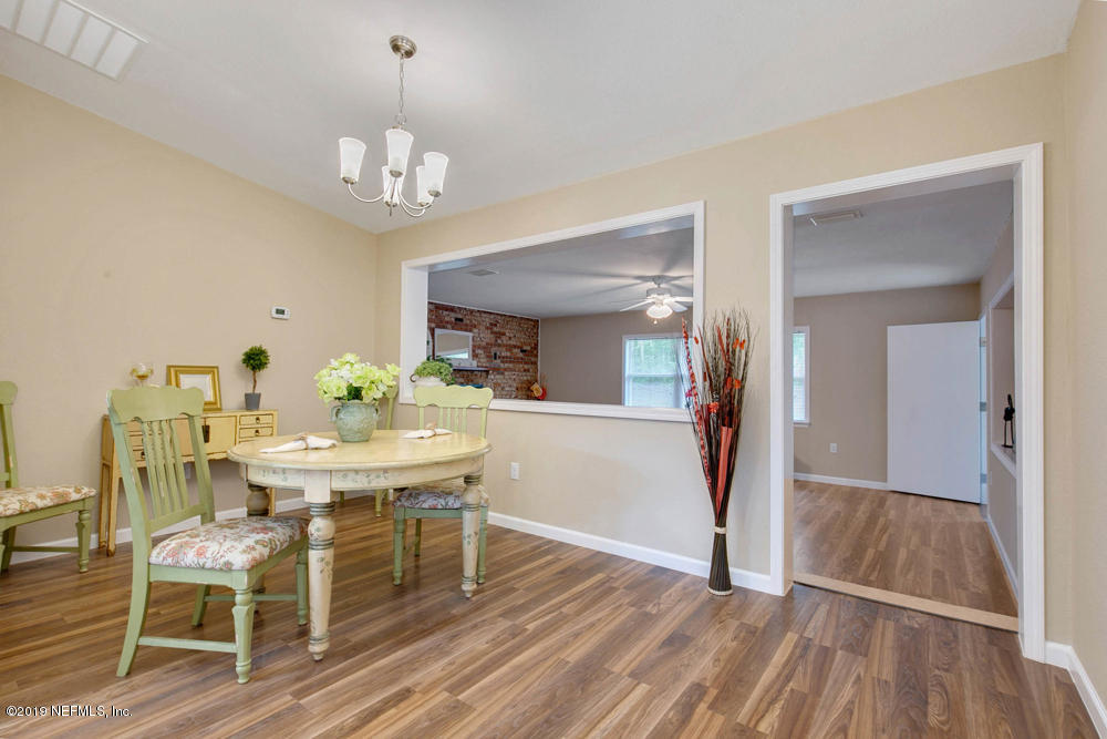 1175 Nightingale Road Jacksonville, FL 32216 - Photo 12 of 35 a view of a dining room with furniture and wooden floor
