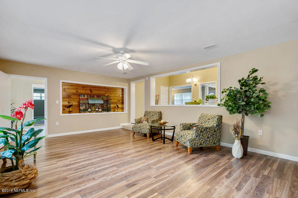 1175 Nightingale Road Jacksonville, FL 32216 - Photo 16 of 35 a living room with furniture and flowers