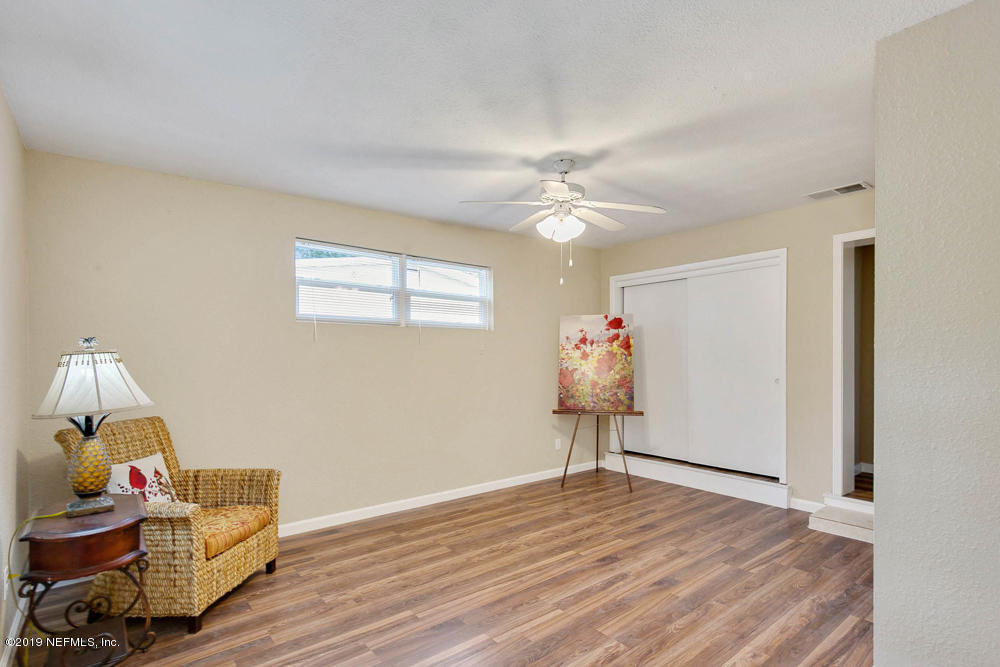 1175 Nightingale Road Jacksonville, FL 32216 - Photo 19 of 35 a view of a livingroom with wooden floor and workspace