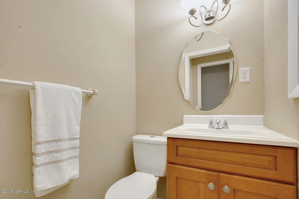 1175 Nightingale Road Jacksonville, FL 32216 - Photo 21 of 35 a bathroom with a toilet sink and mirror
