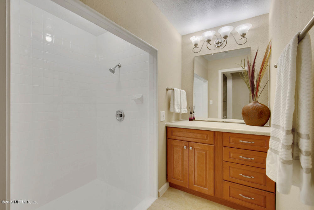 1175 Nightingale Road Jacksonville, FL 32216 - Photo 22 of 35 a spacious bathroom with a double vanity sink and mirror