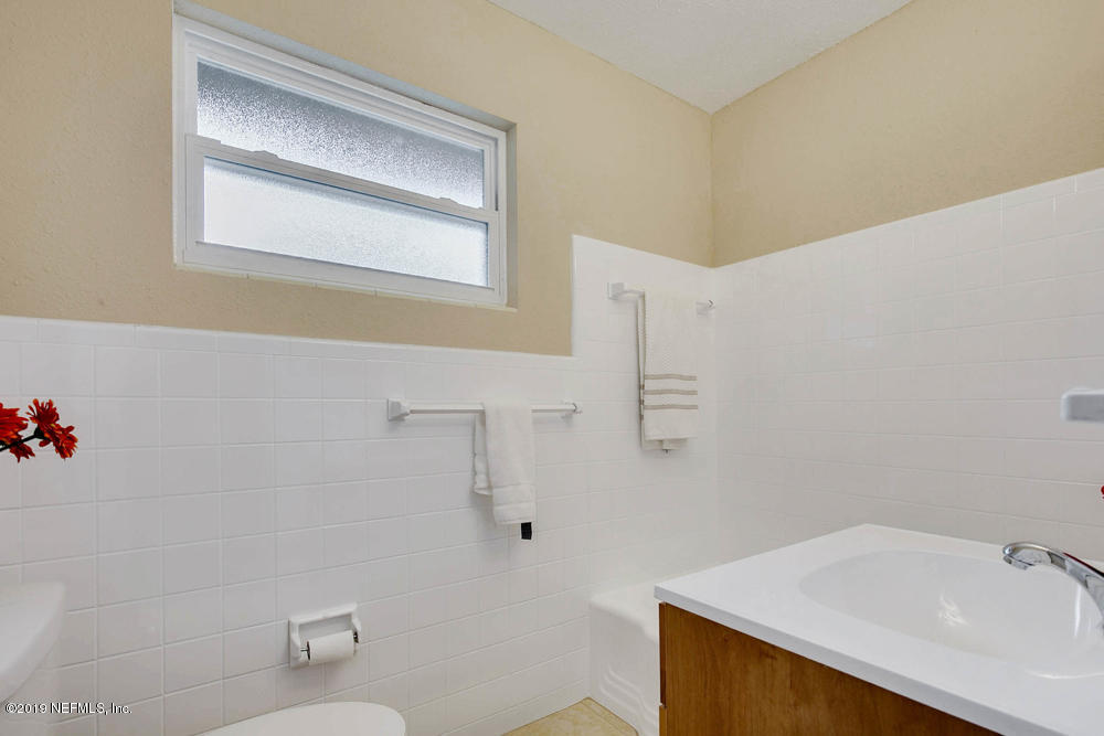 1175 Nightingale Road Jacksonville, FL 32216 - Photo 27 of 35 a bathroom with a sink mirror vanity and toilet
