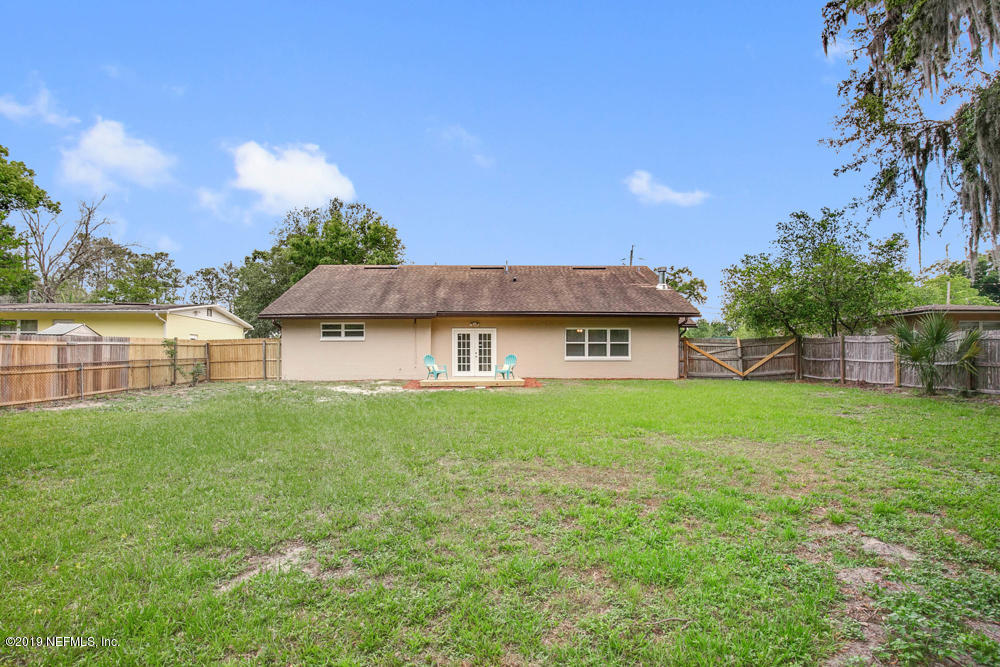 1175 Nightingale Road Jacksonville, FL 32216 - Photo 32 of 35 a view of a house with a yard and a patio