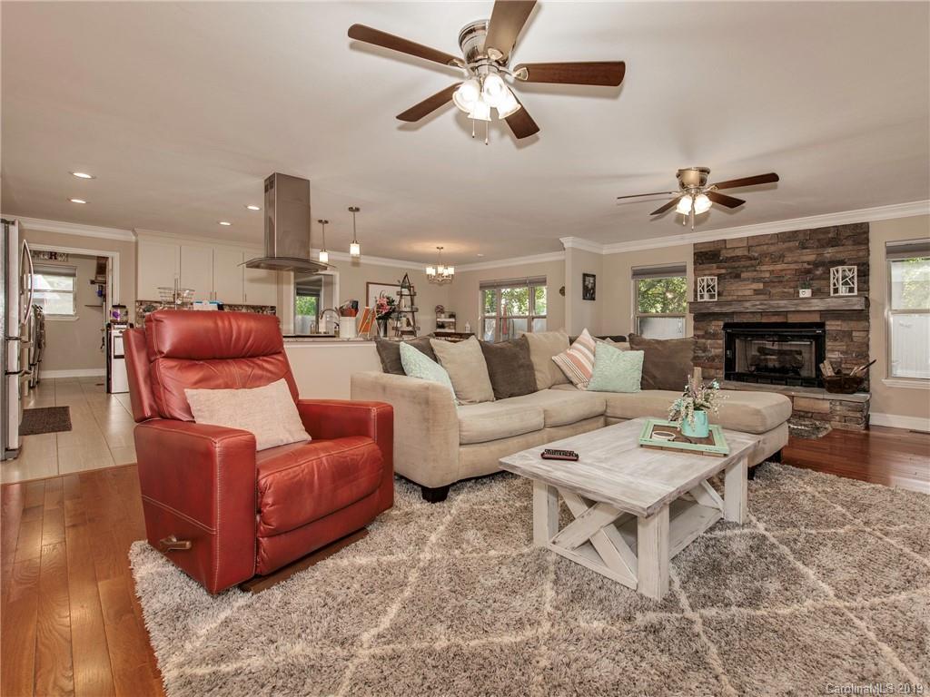 4109 Lake Shore Road South Denver, NC 28037 - Photo 7 of 31 a living room with furniture a fireplace and a ceiling fan