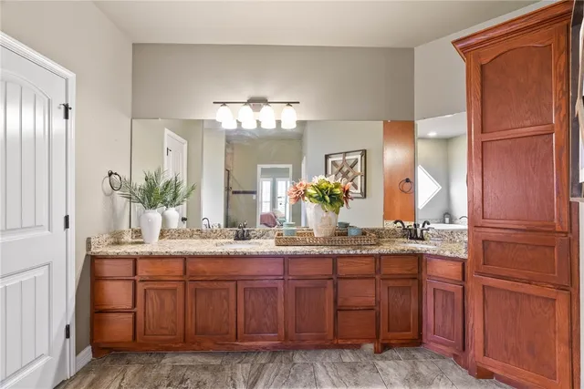 a bathroom with a granite countertop sink and a mirror