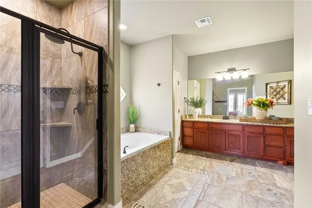 a large bathroom with a glass door shower and sink