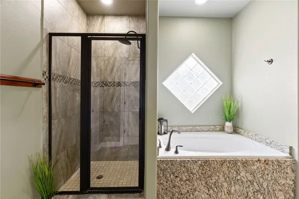 a bathroom with a bathtub and a shower