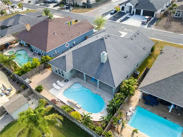 an aerial view of a house with a swimming pool