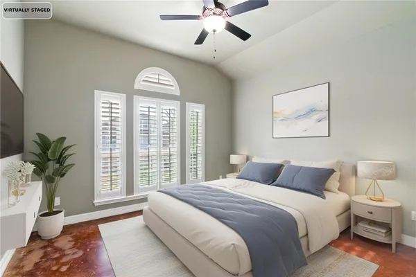 a bedroom with a large bed and a window