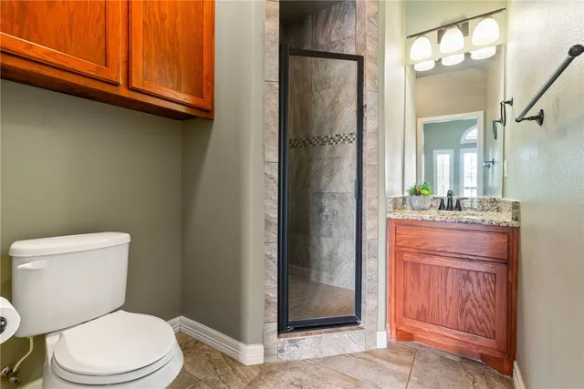 a bathroom with a toilet a sink and a mirror