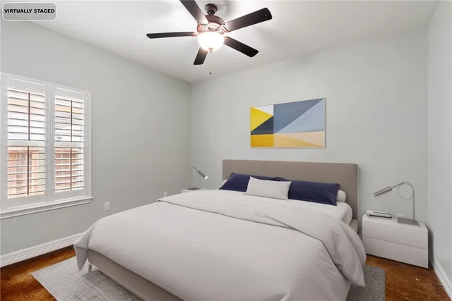 a bedroom with a bed and a painting on the wall