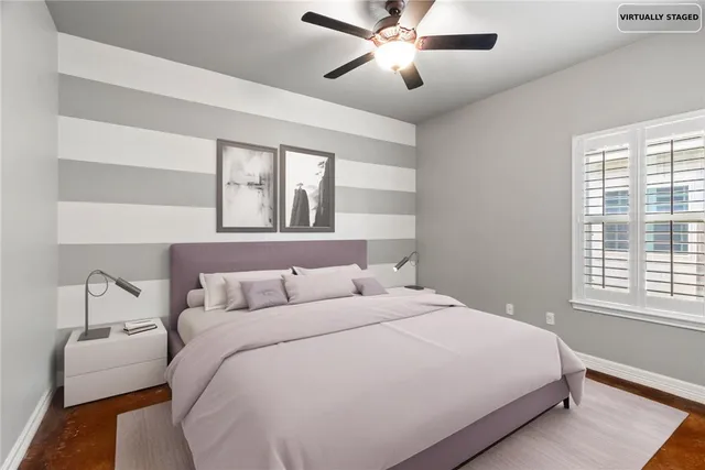 a bedroom with a large bed and a chandelier