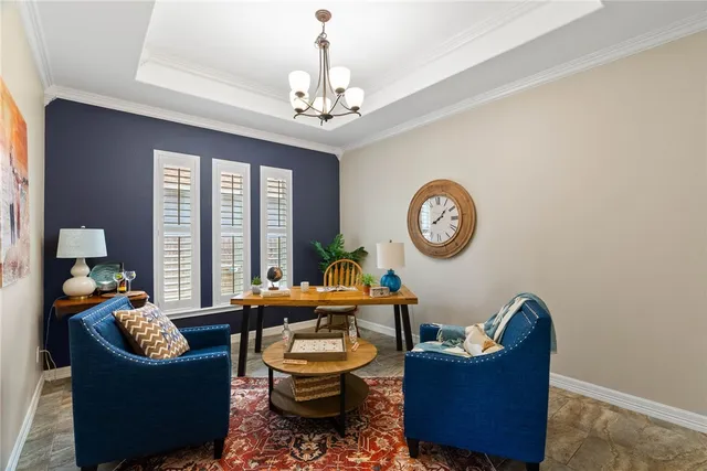 a living room with furniture a chandelier and a window