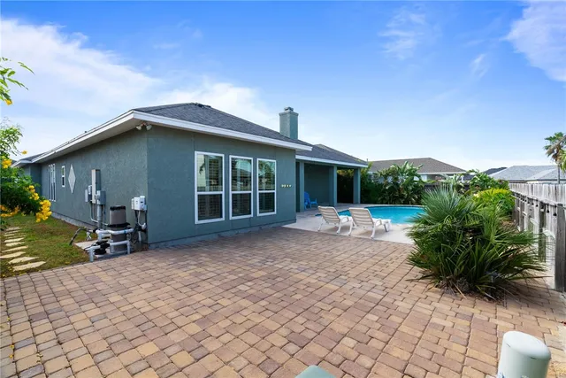 a view of a house with backyard and sitting area