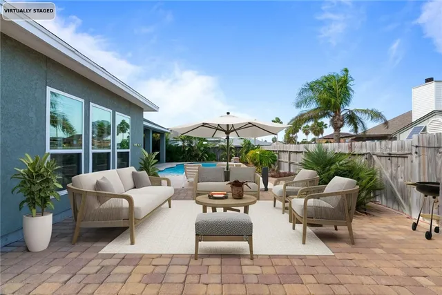 a view of a patio with couches and potted plants