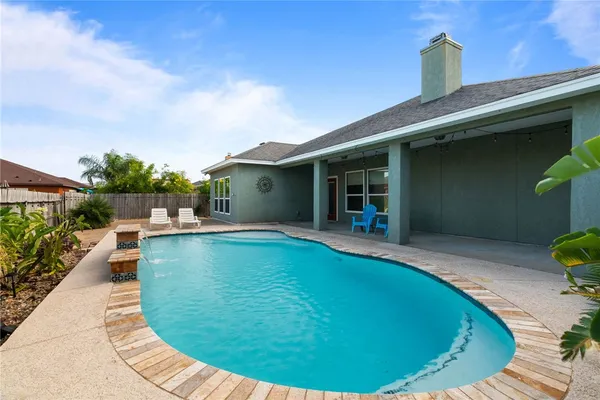 a view of a swimming pool with a patio