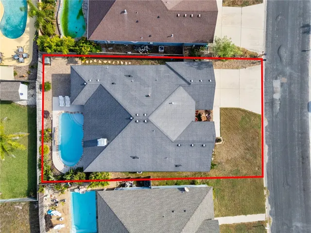 an aerial view of a house with yard ocean and houses view
