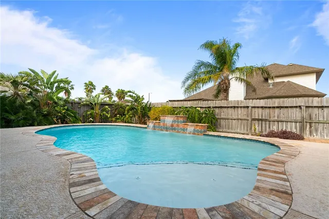 a view of a swimming pool with a yard