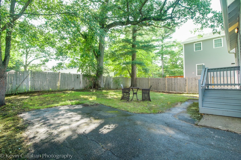 843 Boston Road Billerica, MA 01821 - Photo 4 of 27 a backyard of a house with a fence and trees