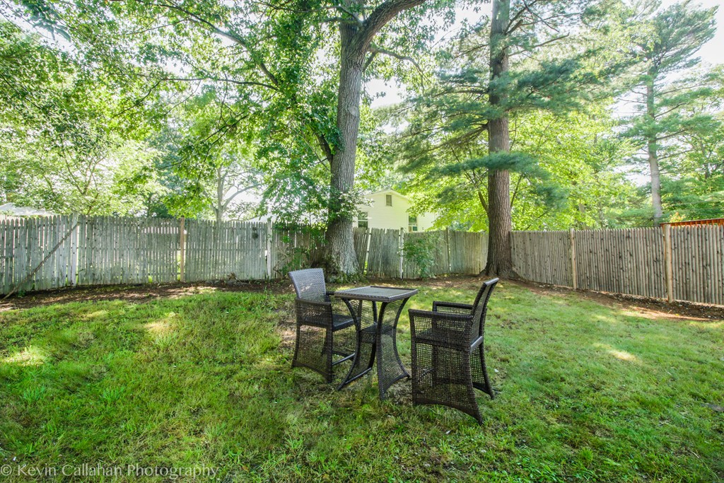 843 Boston Road Billerica, MA 01821 - Photo 5 of 27 a view of a backyard with table and chairs and wooden fence