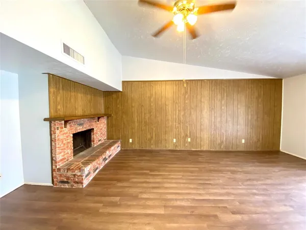 a view of a livingroom with a fireplace and window