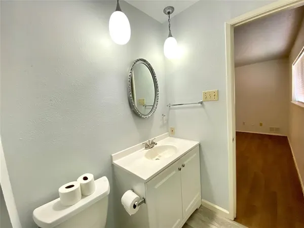 a bathroom with a sink mirror and vanity