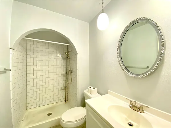 a bathroom with a toilet a sink and a mirror