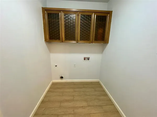 a view of a room with wooden floor and a window