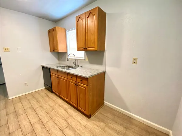 a utility room with a sink a mirror and a vanity