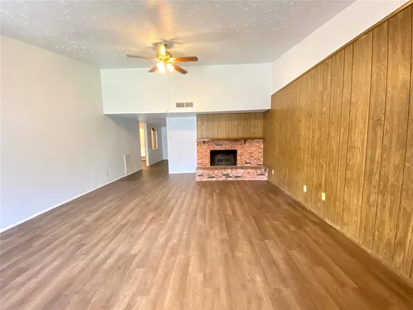 a view of main area with fireplace and wooden floor