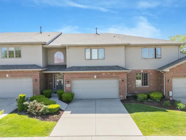 a view of a white house with a yard