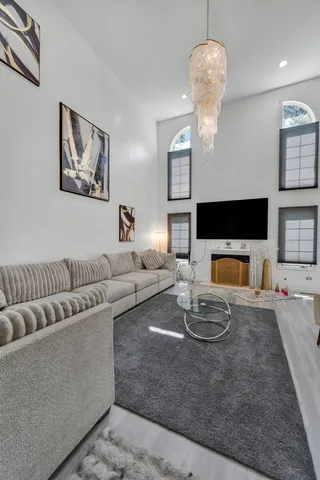 a living room with fireplace furniture and a flat screen tv