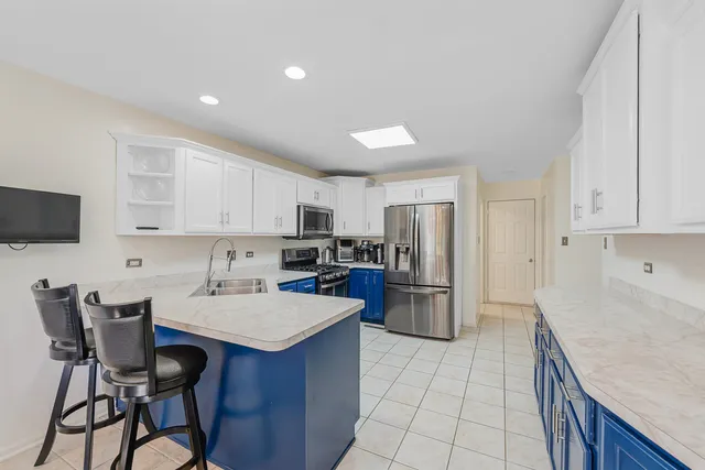 a kitchen with a refrigerator and a stove top oven