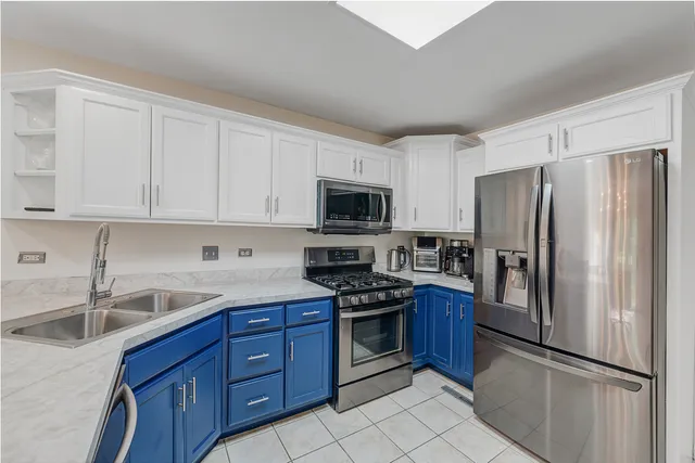 a kitchen with stainless steel appliances granite countertop a refrigerator stove a sink and dishwasher