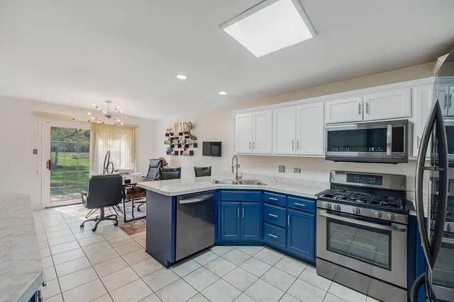 a kitchen with a sink cabinets and stainless steel appliances