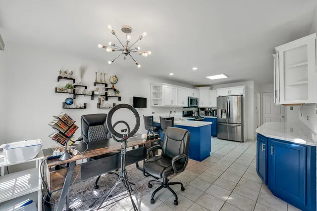 a view of a kitchen with dining table and chairs