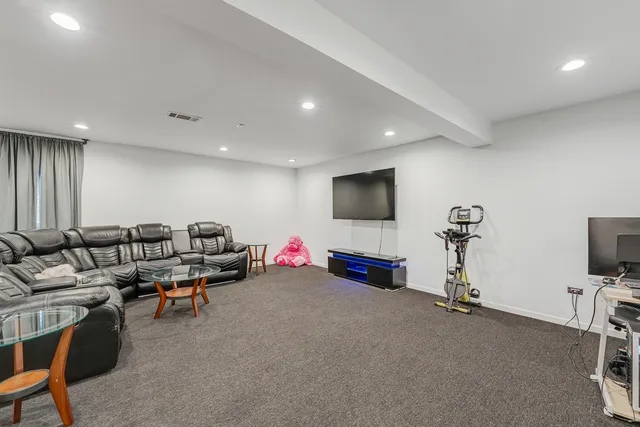 a room with gym equipment and a flat screen tv