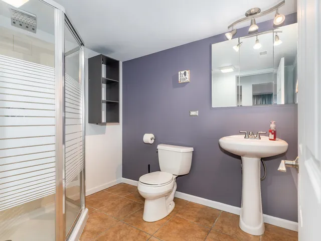 a bathroom with a sink toilet and mirror