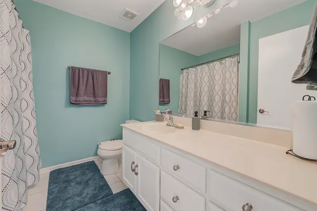 a bathroom with a double vanity sink mirror and toilet