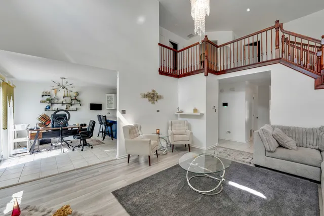 a living room with furniture and a chandelier