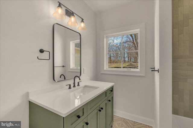 a spacious bathroom with a mirror and a shower