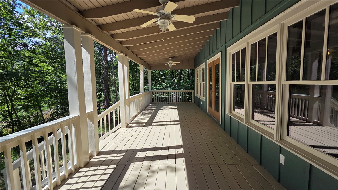 517 Chimney Ridge Westminster, SC 29693 - Photo 22 of 32 An inviting covered porch offers serene outdoor living amidst a lush, wooded backdrop.