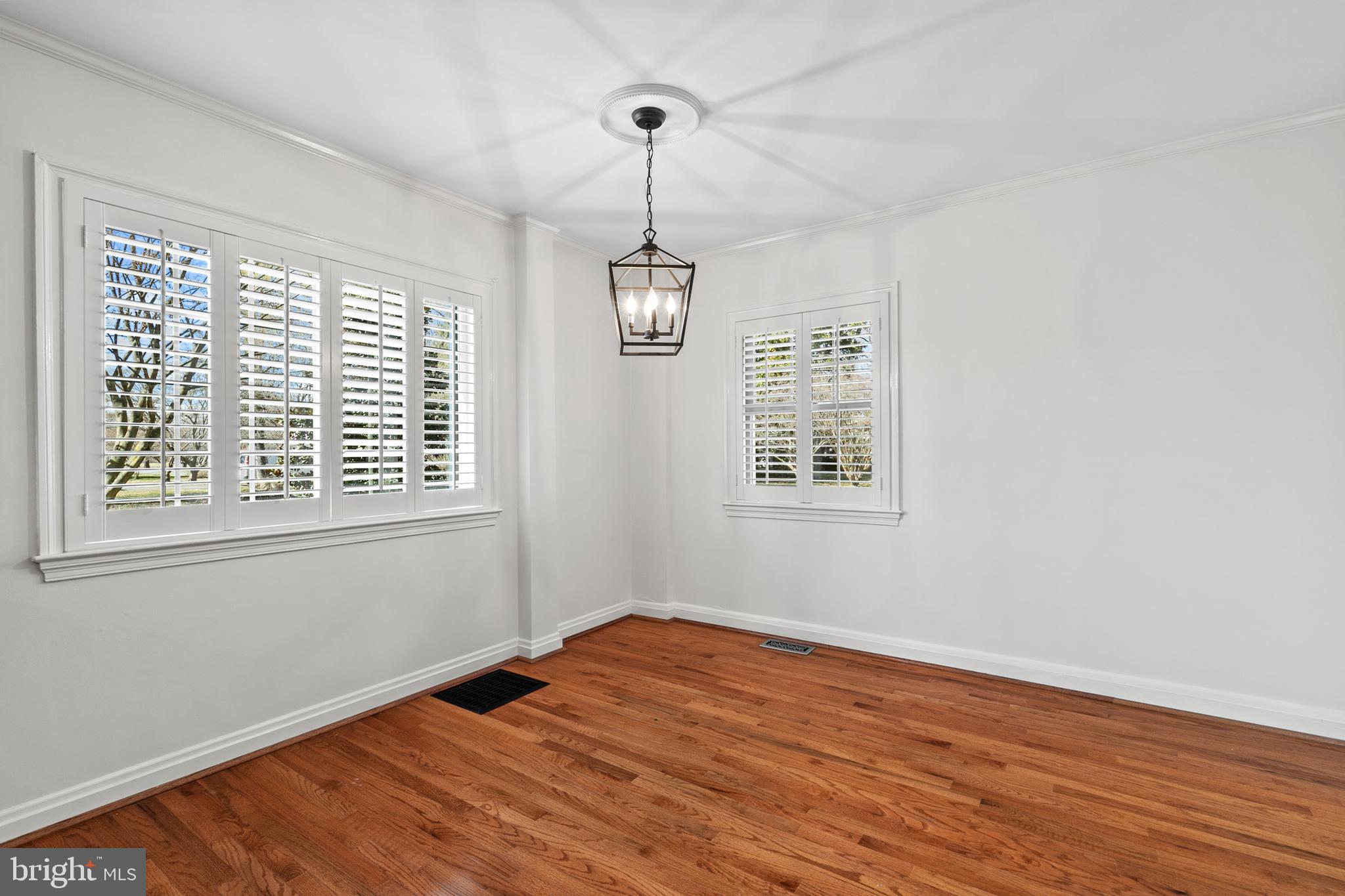727 Whitehall Beach Road Annapolis, MD 21409 - Photo 11 of 44 a view of an empty room with wooden floor and a window