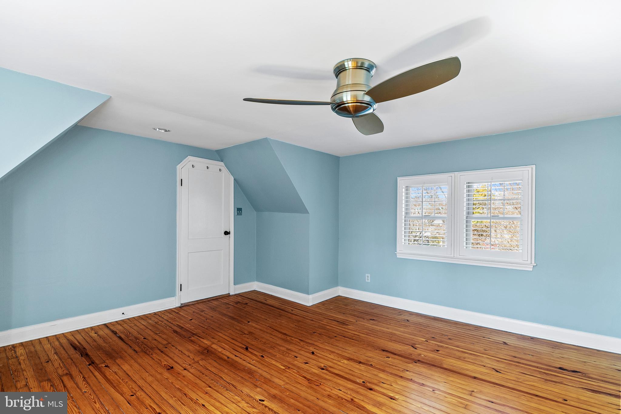 727 Whitehall Beach Road Annapolis, MD 21409 - Photo 22 of 44 a view of a room with a wooden floor and ceiling fan