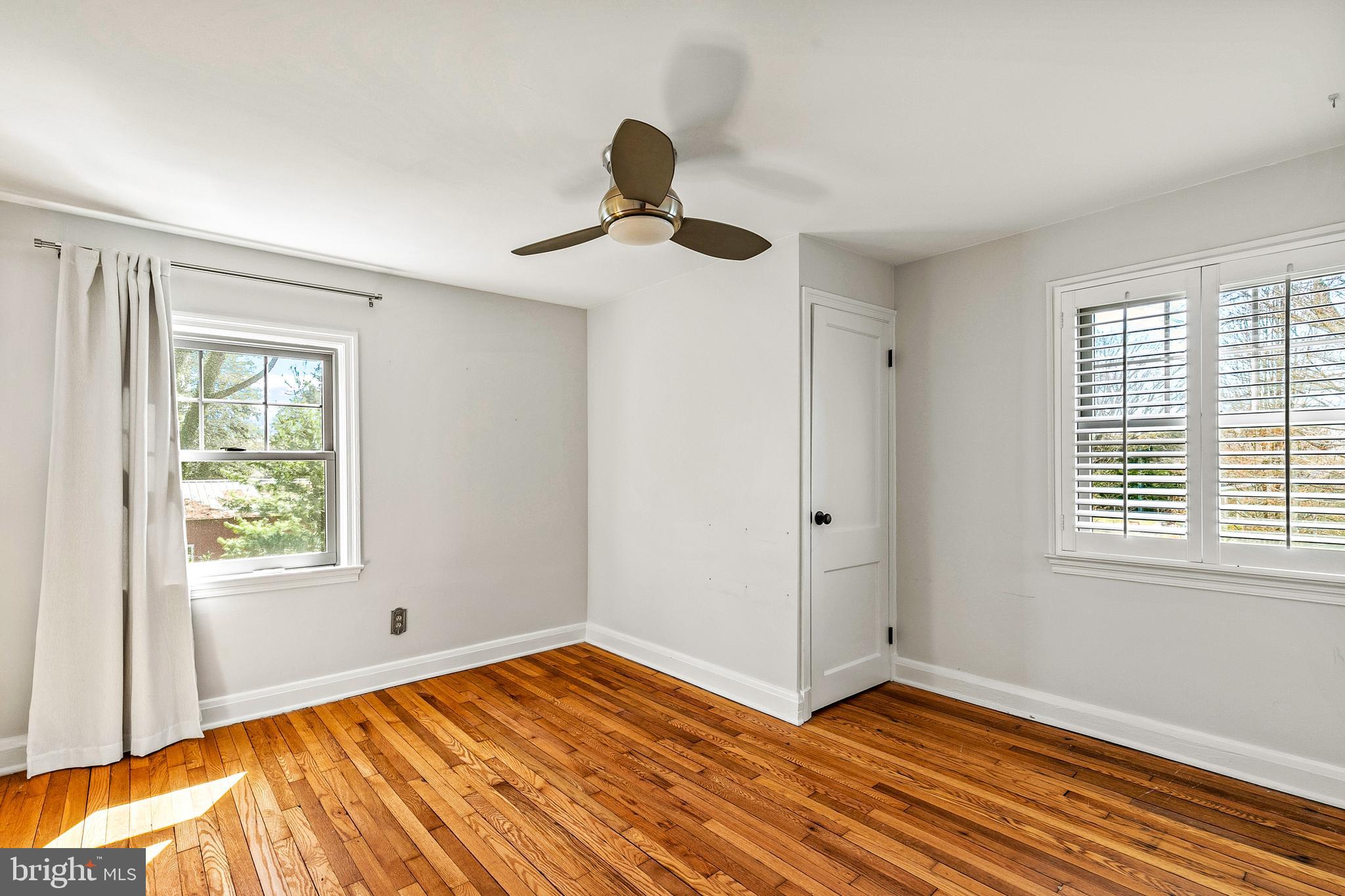727 Whitehall Beach Road Annapolis, MD 21409 - Photo 24 of 44 a view of an empty room with window and wooden floor