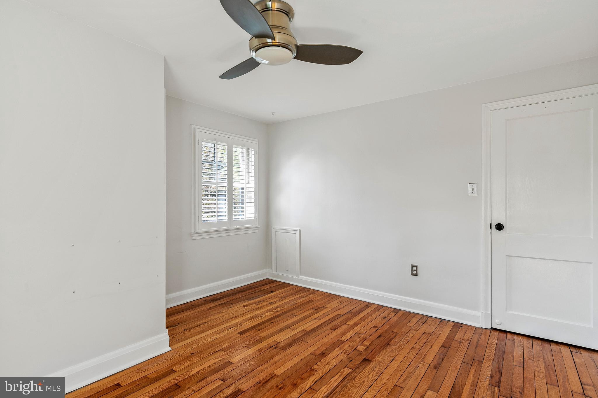 727 Whitehall Beach Road Annapolis, MD 21409 - Photo 25 of 44 a view of empty room with wooden floor and fan