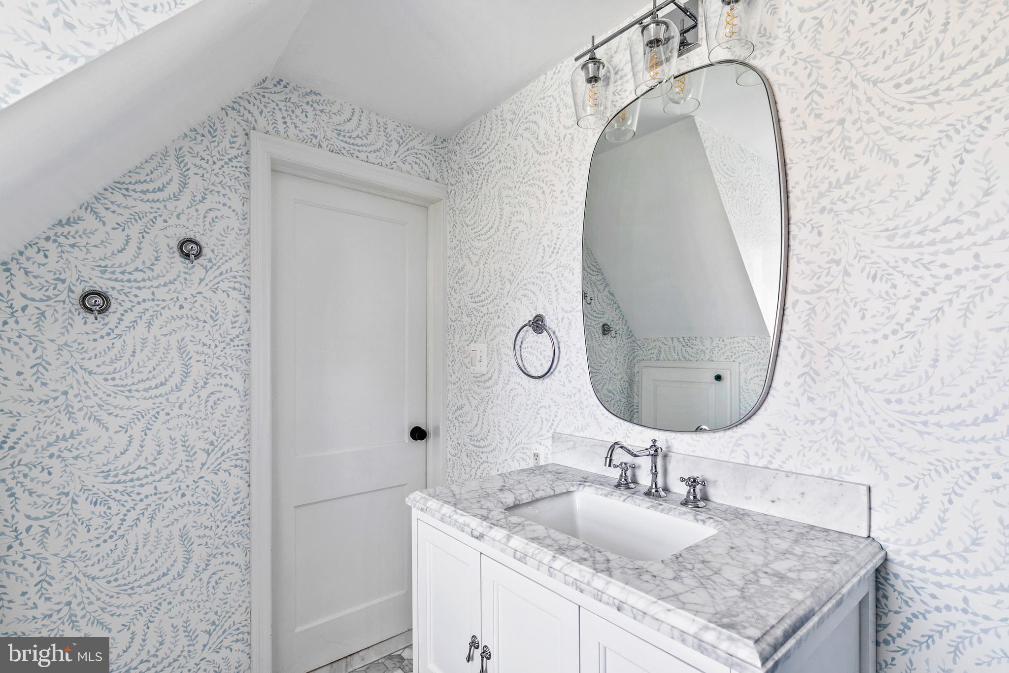 727 Whitehall Beach Road Annapolis, MD 21409 - Photo 27 of 44 a bathroom with a granite countertop sink a mirror and shower