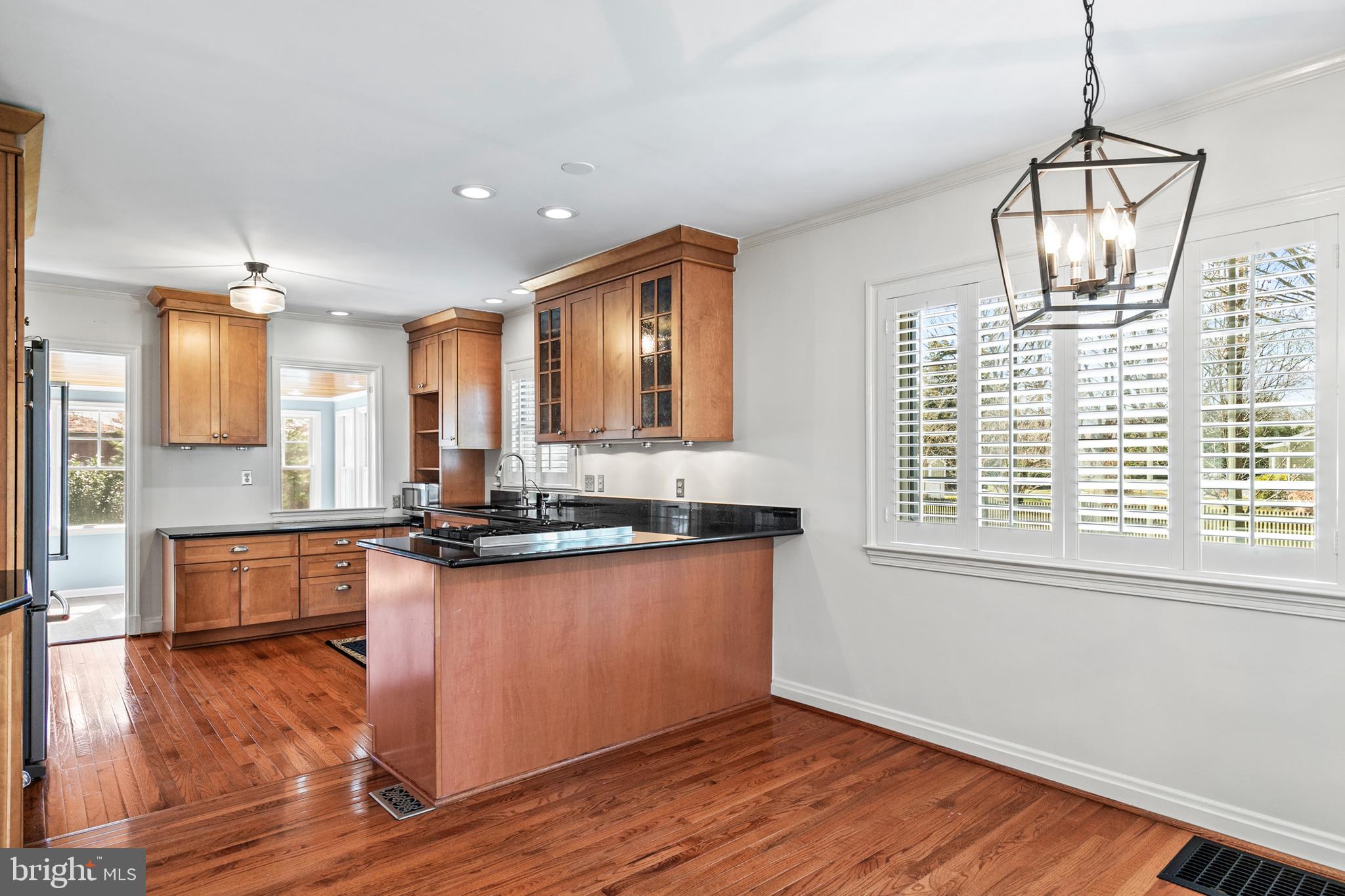 727 Whitehall Beach Road Annapolis, MD 21409 - Photo 6 of 44 a large kitchen with stainless steel appliances granite countertop a stove and a wooden floors